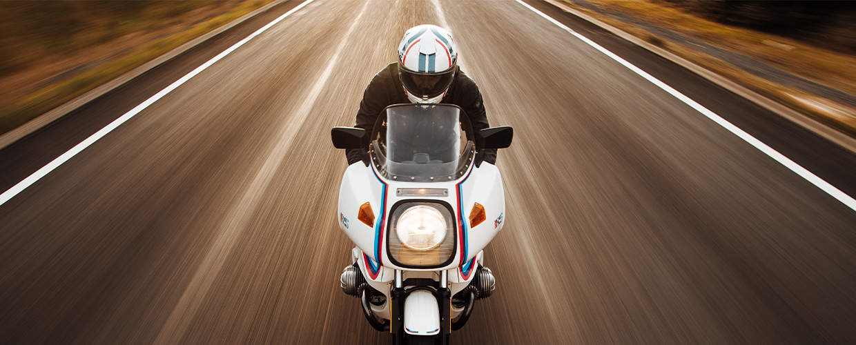 behind the brand banner - person riding towards screen