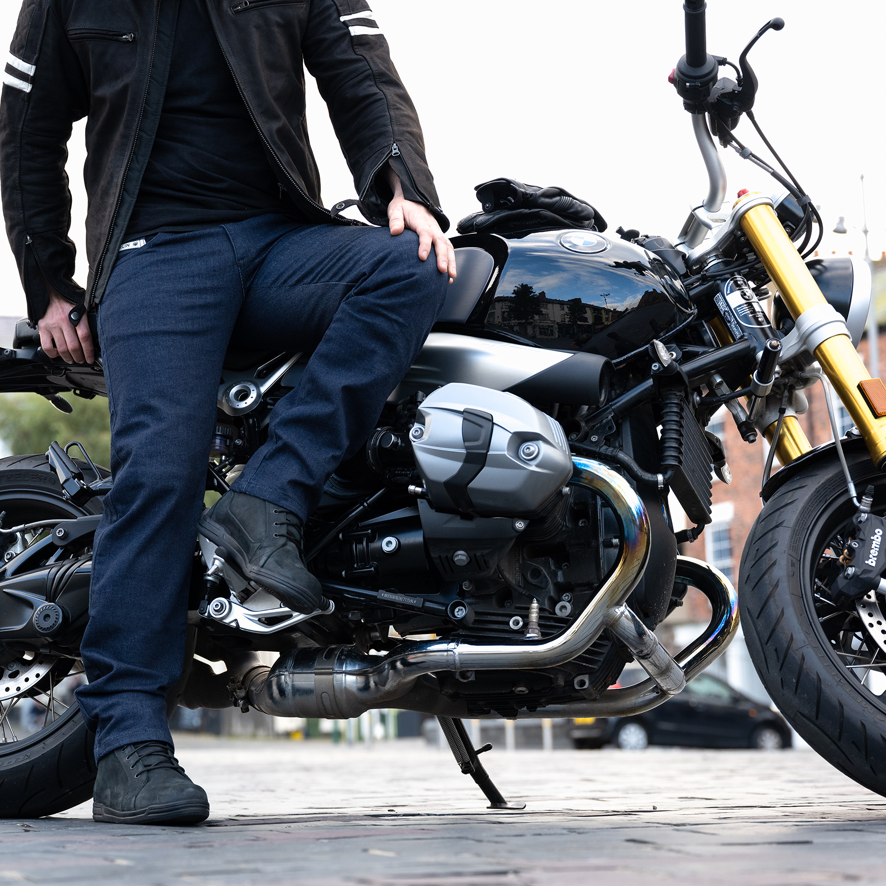 Lifestyle image of Merlin Alexander riding jeans in blue